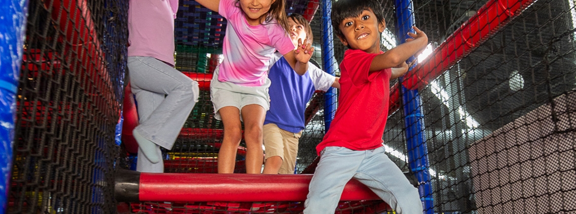 kids climbing inside the padded playscape inside at Mt Playmore